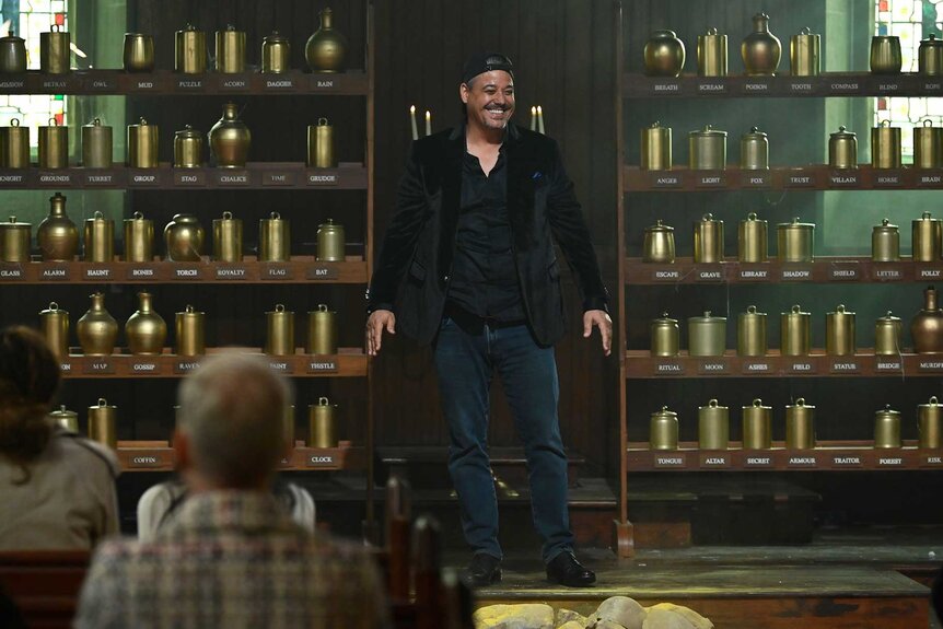 Boston Rob Mariano smiling and entering a room on The Traitors Season 3, Episode 5.