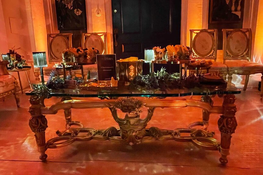 A decorative table in a room in The Traitors Experience.