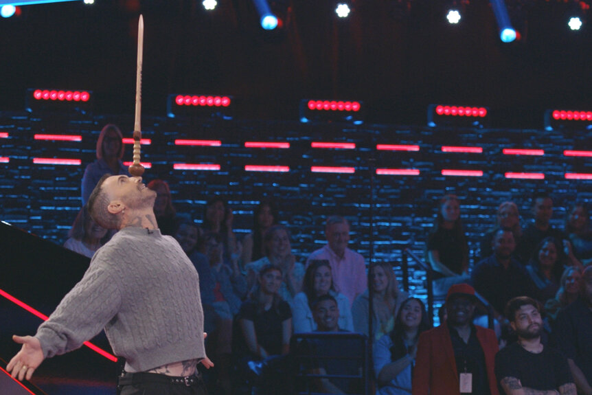 Adam Levine balances a stick on his nose on the voice season 27 episode 3