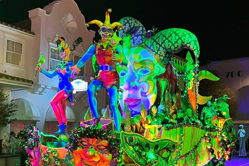 Guests on top of a float during Universal Orlando Resort's Mardi Gras Celebration.