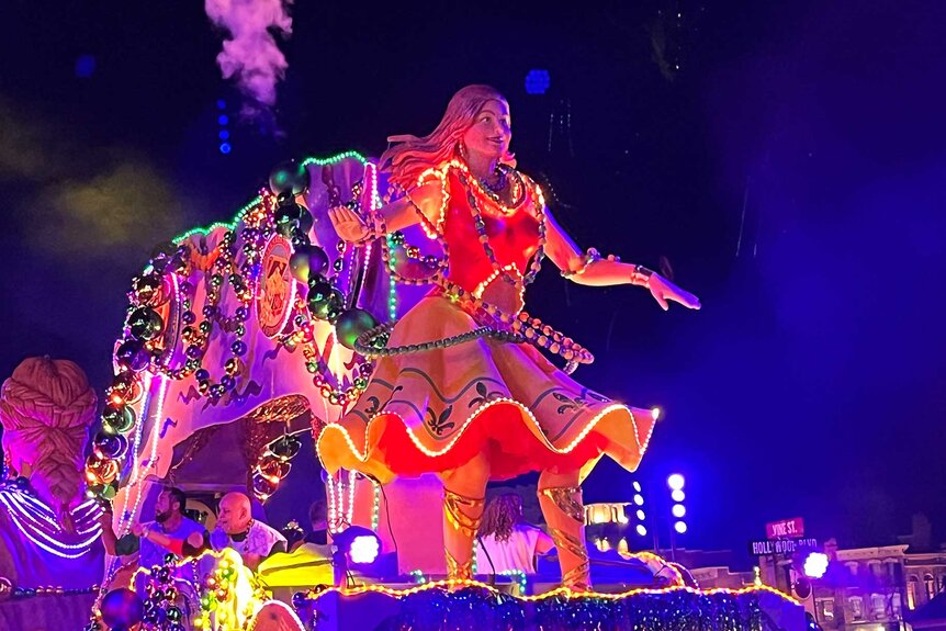 Guests on top of a float during Universal Orlando Resort's Mardi Gras Celebration.