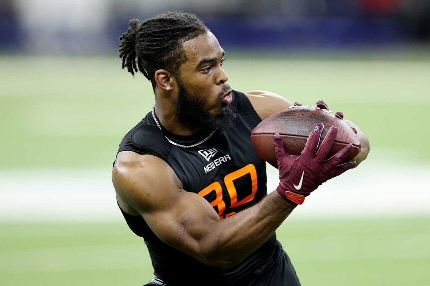 Bhayshul Tuten catching a ball during a drill for the NFL Scouting Combine.