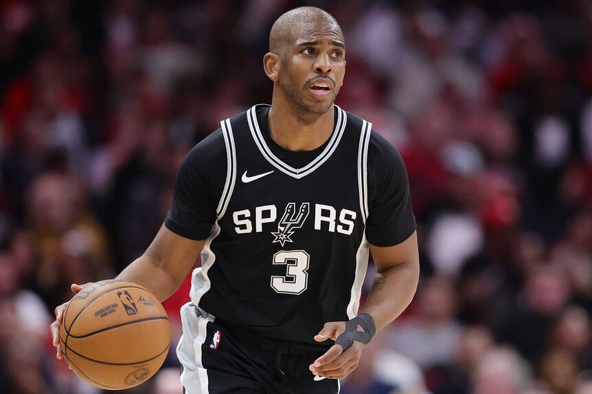 Chris Paul dribbling the ball in a game against the Houston Rockets.