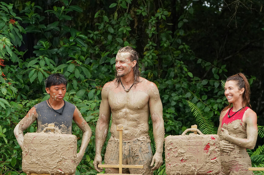 Parvati Shallow, David Genat, and Dickson Wong covered in mud in Deal or No Deal Island Season 2, Episode 9.