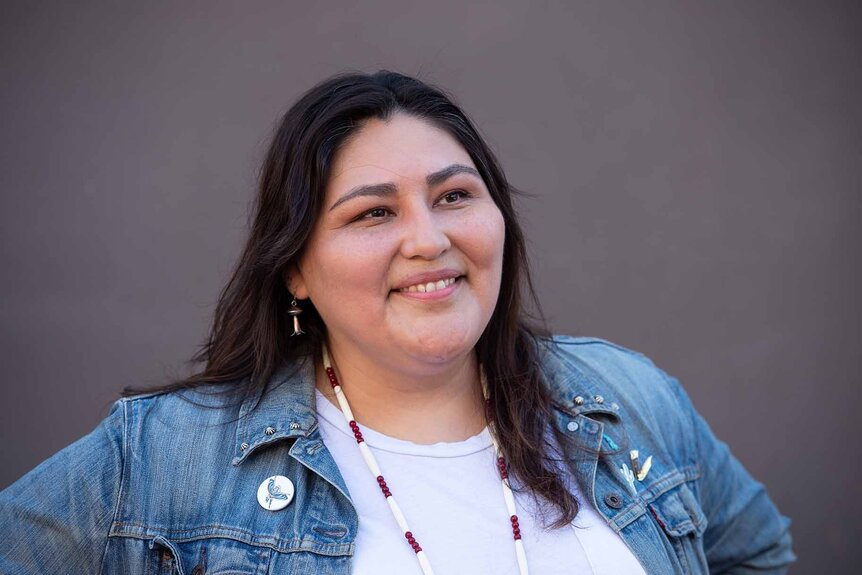 Sierra Teller Ornelas smiles in a denim jacket.