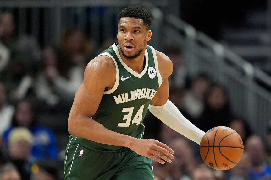 Giannis Antetokounmpo dribbling the ball during a game against the Denver Nuggets.