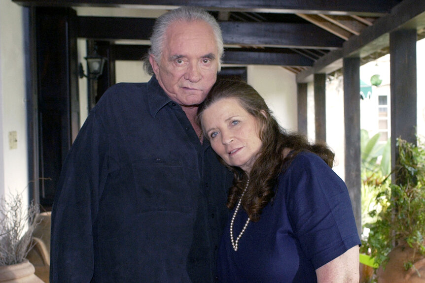 Johnny Cash and June Carter Cash pose together in their home