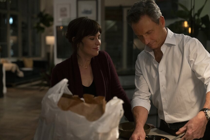 Atty. Kate Norris (Maggie Siff) and DA Nicholas Baxter (Tony Goldwyn) open their takeout order on Law & Order Episode 2415.