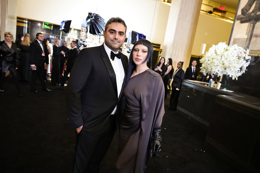 Michael Polansky and Lady Gaga in formal wear on a red carpet.