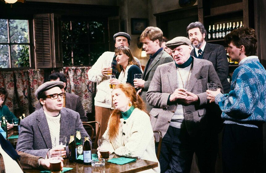 Mike Myers, Kevin Nealon, Jan Hooks, Conan O'brien, and Terry Turner gathered together in a pub during Saturday Night Live Season 15, Episode 15.