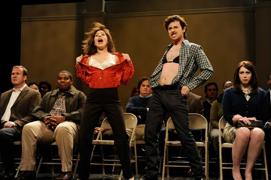 Lady Gaga and John Milhiser ripping their shirts off during a sketch on Saturday Night Live Season 39, Episode 6.