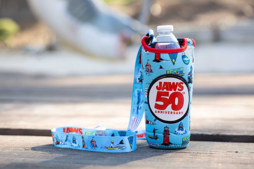 A Koozie with a water bottle inside for Universal Studios Jaws 50th Anniversary.