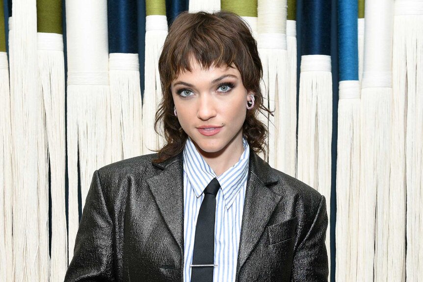 Violett Beane smiling and posing backstage before the Death and Other Details panel.